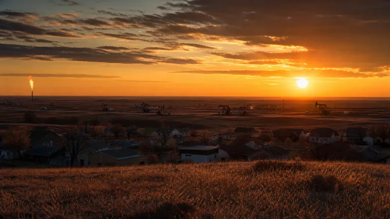 Western prairie oil-patch town edge with pumpjacks and a flare on the horizon at dusk, Williston Business License